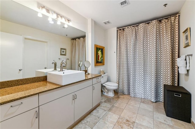 bathroom with toilet and vanity