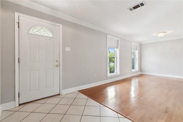 foyer entrance featuring ornamental molding and light tile patterned floors