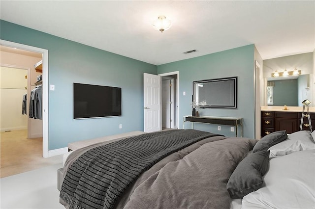 bedroom featuring ensuite bathroom, a closet, and a spacious closet