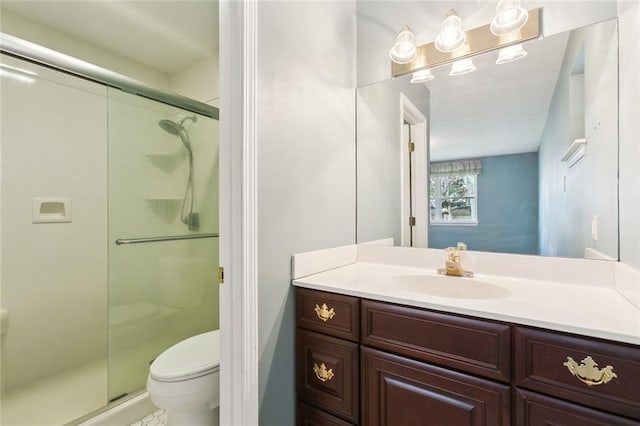 bathroom with walk in shower, vanity, and toilet