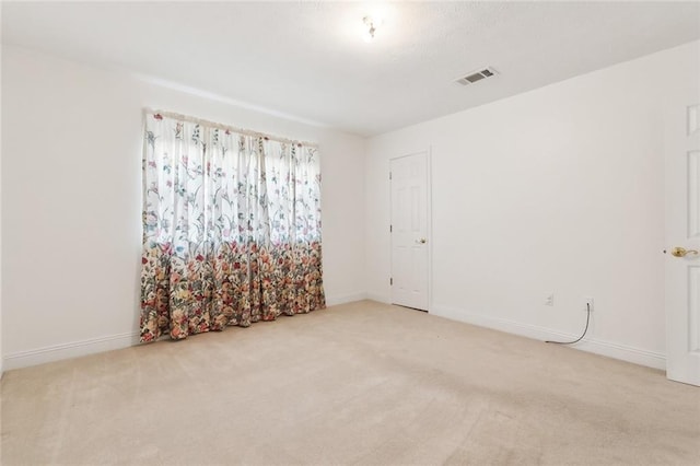 empty room with light colored carpet