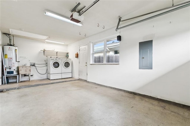 garage featuring gas water heater, sink, electric panel, and separate washer and dryer