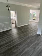 interior space featuring ornamental molding and dark hardwood / wood-style floors