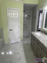 bathroom featuring an enclosed shower and vanity