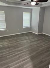 spare room featuring ceiling fan and dark hardwood / wood-style floors