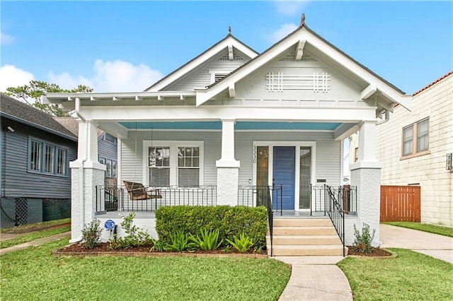 craftsman-style home with covered porch and a front yard