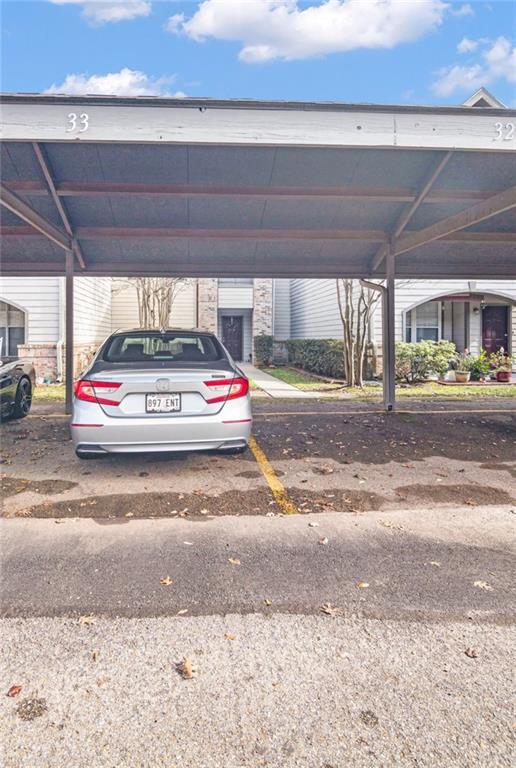 view of vehicle parking with a carport