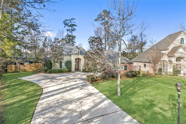 french country style house featuring a front lawn