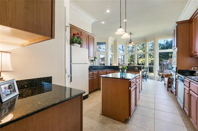 kitchen featuring stainless steel appliances, a center island, light tile patterned floors, ornamental molding, and decorative light fixtures