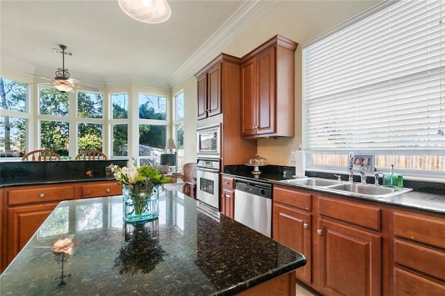 kitchen featuring pendant lighting, stainless steel appliances, plenty of natural light, ceiling fan, and sink