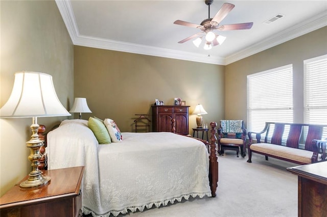 carpeted bedroom featuring ceiling fan and crown molding