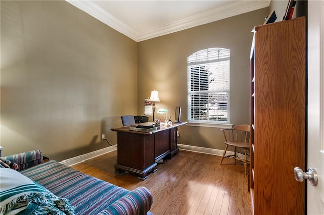 home office with ornamental molding and hardwood / wood-style floors