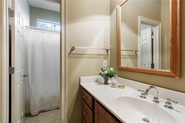 bathroom with a shower with shower curtain, vanity, and tile patterned flooring