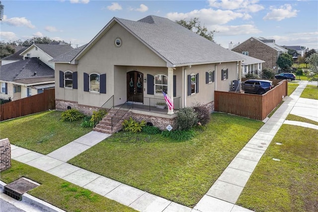 view of front of home with covered porch and a front lawn