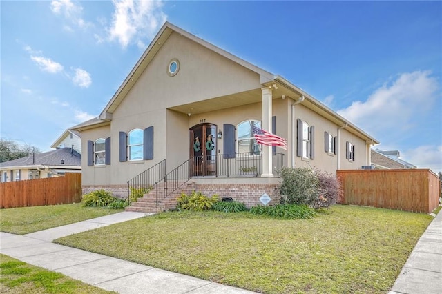 view of front of property with covered porch and a front yard