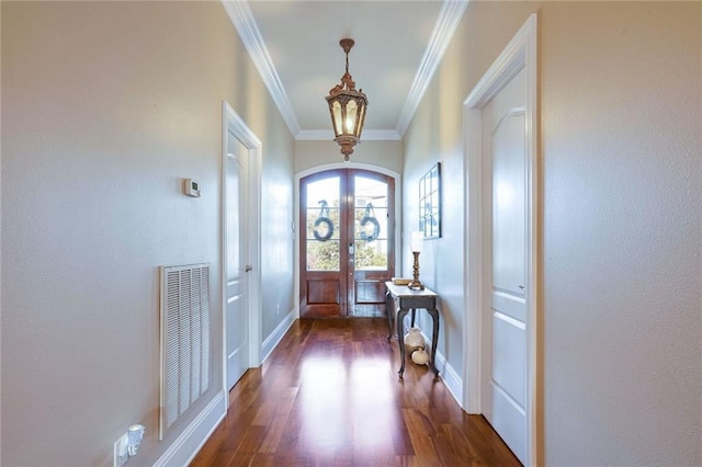 entryway with dark wood-type flooring, french doors, and ornamental molding