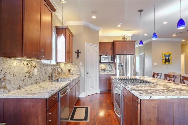 kitchen with pendant lighting, a breakfast bar, decorative backsplash, appliances with stainless steel finishes, and sink