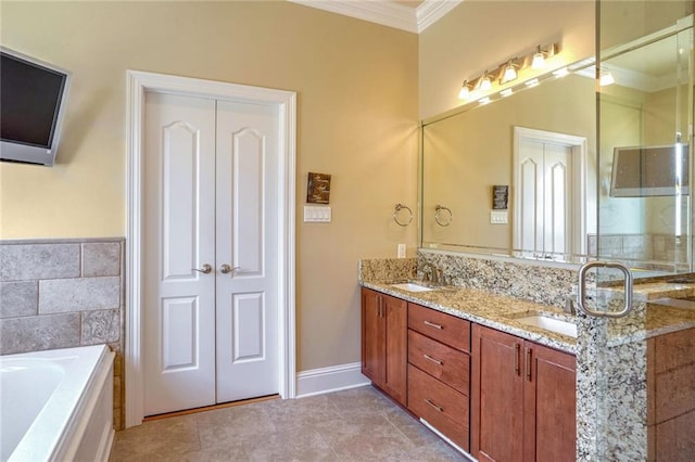 bathroom with a tub, tile patterned flooring, ornamental molding, and vanity