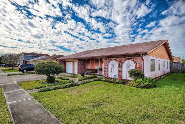 ranch-style home featuring a front yard and a garage