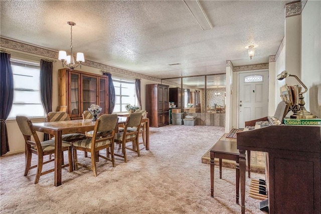 carpeted dining space featuring a textured ceiling and an inviting chandelier