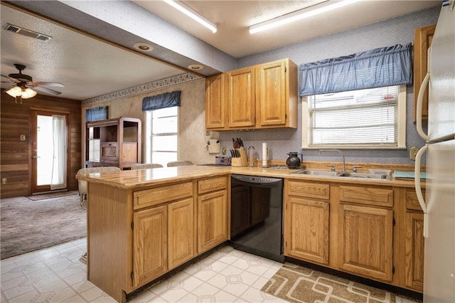 kitchen featuring kitchen peninsula, dishwasher, white refrigerator, ceiling fan, and sink