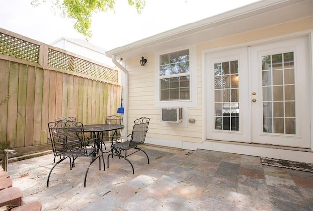 view of patio / terrace with french doors and an AC wall unit