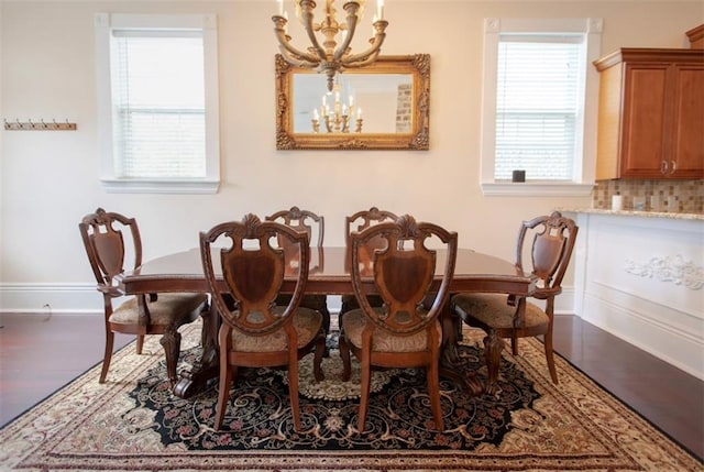 dining space featuring a notable chandelier and a healthy amount of sunlight