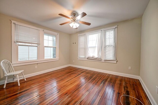 kitchen featuring white appliances, dark hardwood / wood-style flooring, decorative light fixtures, and kitchen peninsula