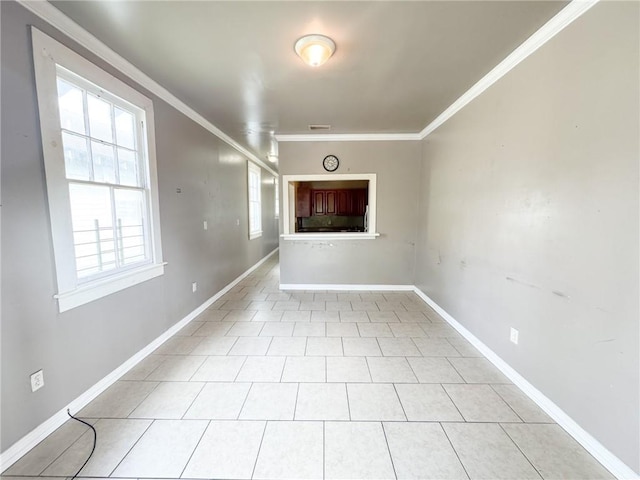 tiled spare room with ornamental molding