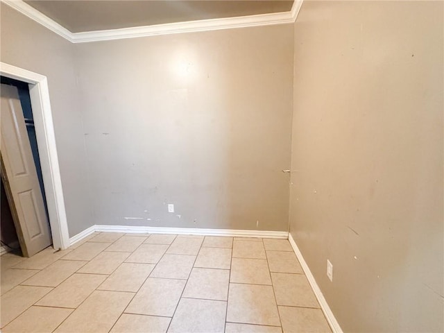 tiled spare room with ornamental molding