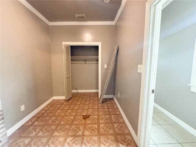 unfurnished bedroom with ornamental molding and a closet