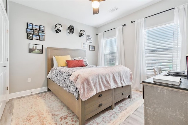 bedroom with light wood-type flooring and ceiling fan