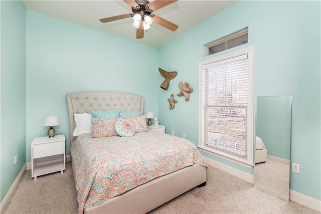 bedroom with ceiling fan and light carpet