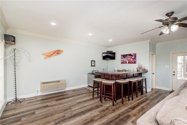 dining area with ceiling fan, ornamental molding, and dark wood-type flooring