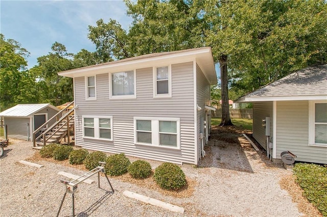 view of front of house featuring a storage unit