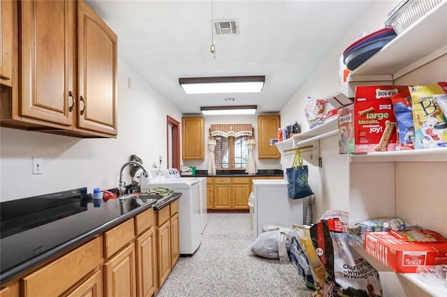 kitchen with washer and dryer and sink