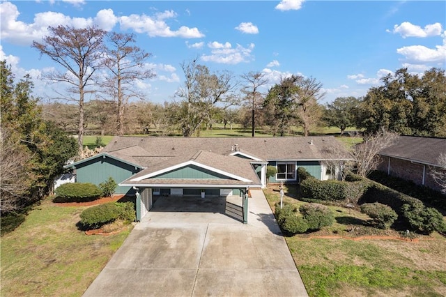 ranch-style house featuring a carport and a front lawn