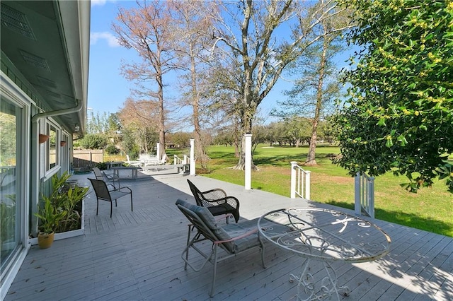 wooden deck featuring a yard