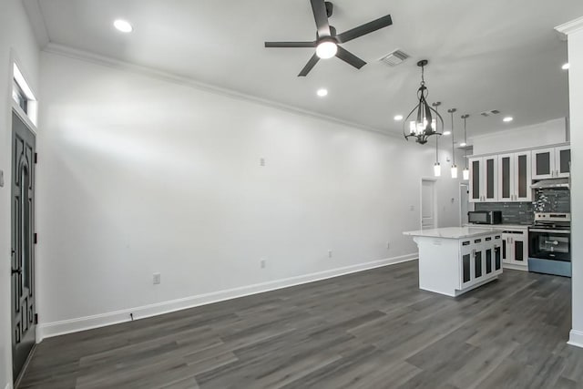 kitchen featuring stainless steel electric stove, decorative light fixtures, a center island, white cabinets, and decorative backsplash