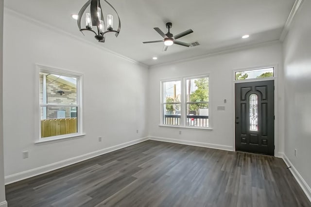 entrance foyer with ceiling fan with notable chandelier, ornamental molding, and dark hardwood / wood-style floors