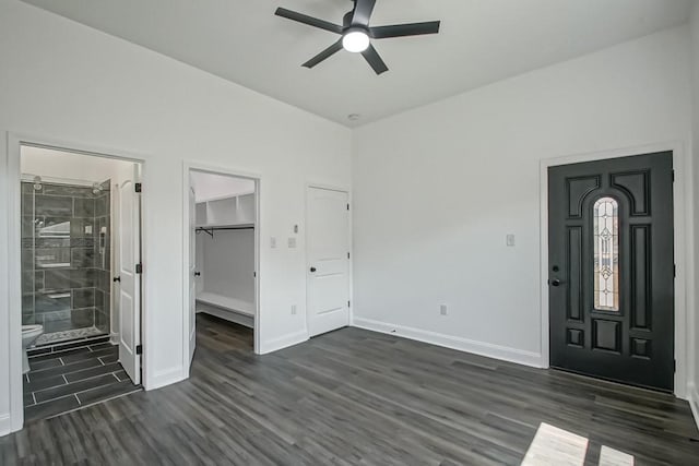 entryway with dark hardwood / wood-style flooring and ceiling fan