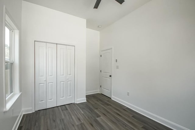 unfurnished bedroom featuring ceiling fan, a closet, and dark hardwood / wood-style floors