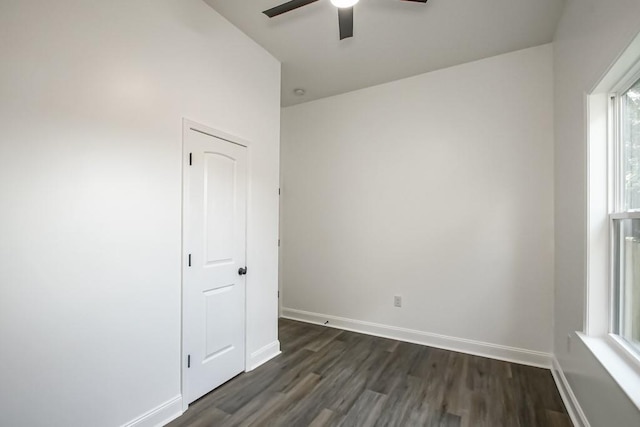 unfurnished room with ceiling fan and dark hardwood / wood-style flooring