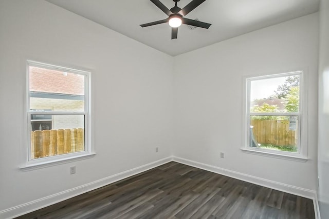 spare room with ceiling fan and dark hardwood / wood-style floors