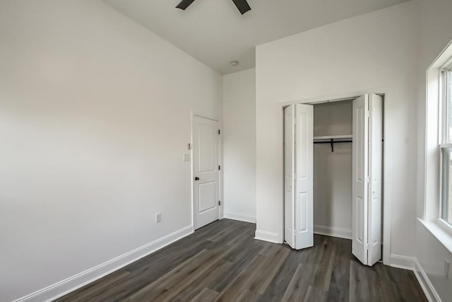 unfurnished bedroom with ceiling fan, a closet, and dark hardwood / wood-style floors