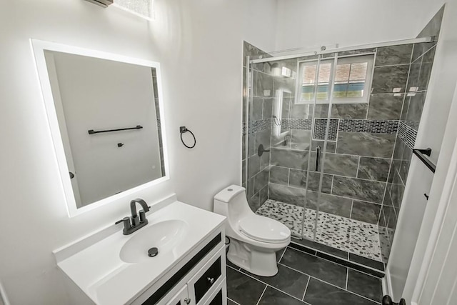 bathroom with tile patterned floors, an enclosed shower, vanity, and toilet