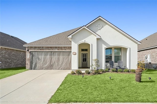 view of front of house with a front yard and a garage