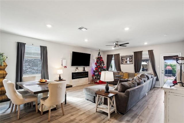 living room featuring light hardwood / wood-style floors and ceiling fan