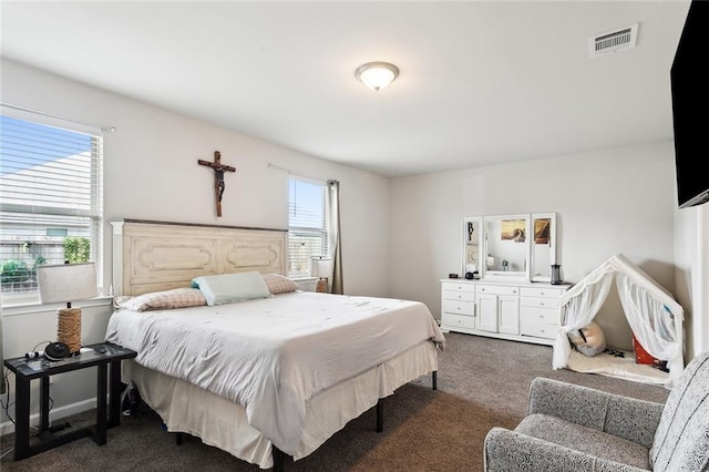 carpeted bedroom featuring multiple windows