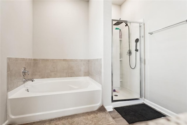 bathroom with separate shower and tub